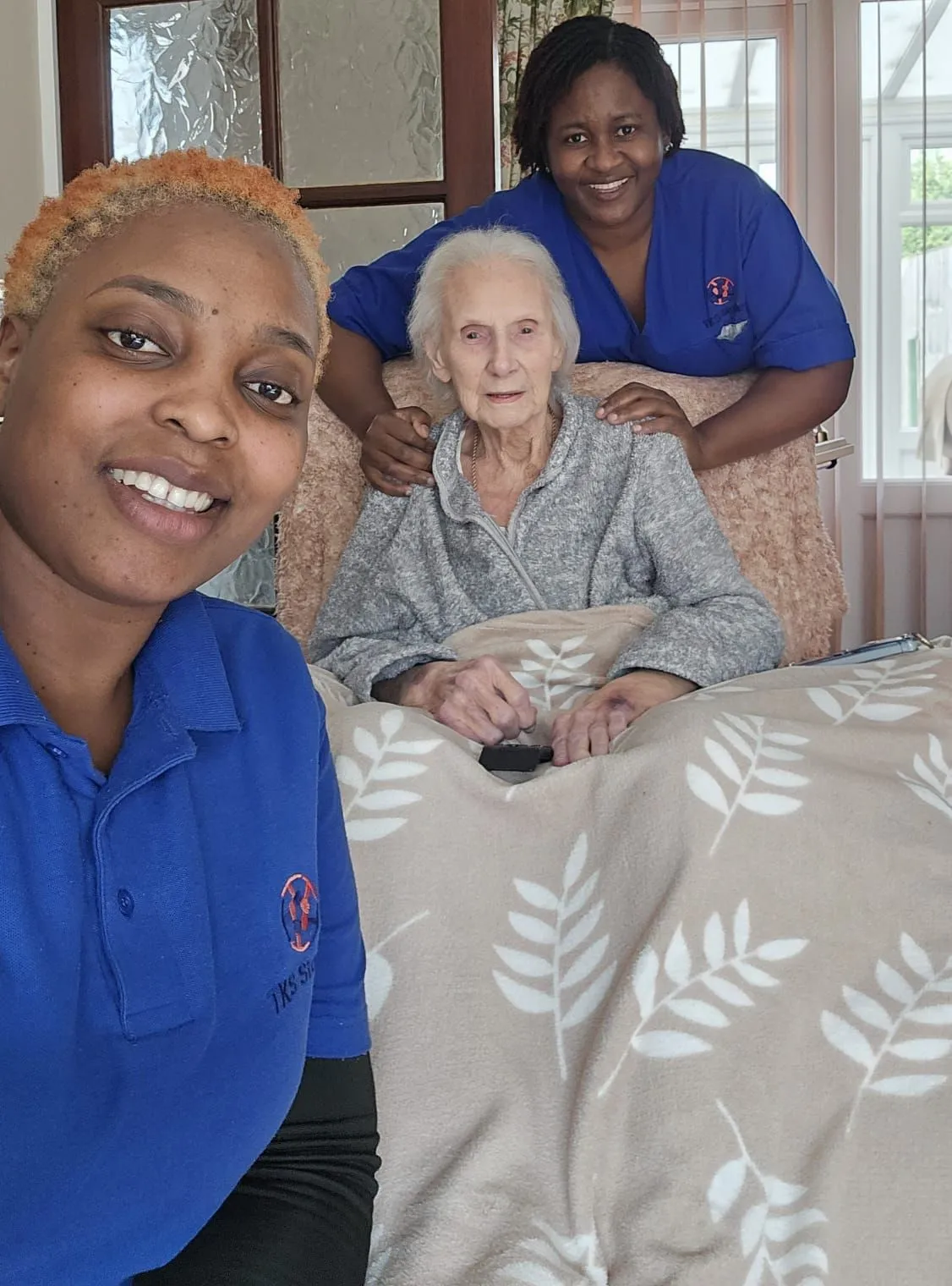 TKS Staffing night carer taking a glass of water to a client's room during overnight care in Derbyshire