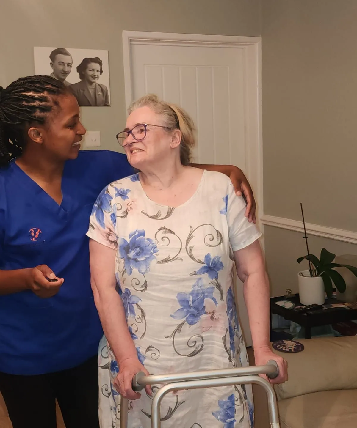 TKS Staffing carer helping an elderly client with his shoes during a personal care visit in Derby